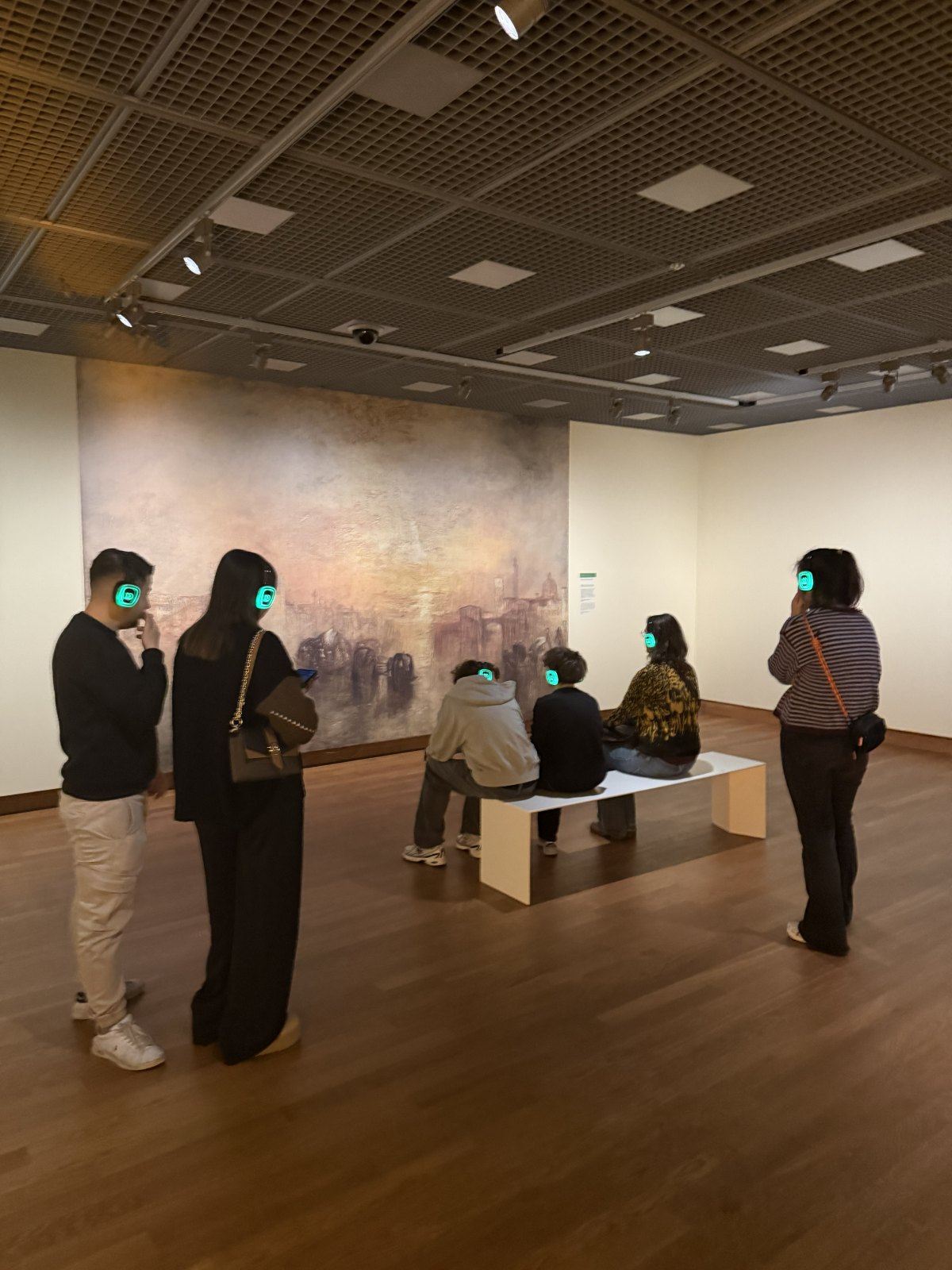 Museum visitors with Dolly Digital headphones in front of a painting