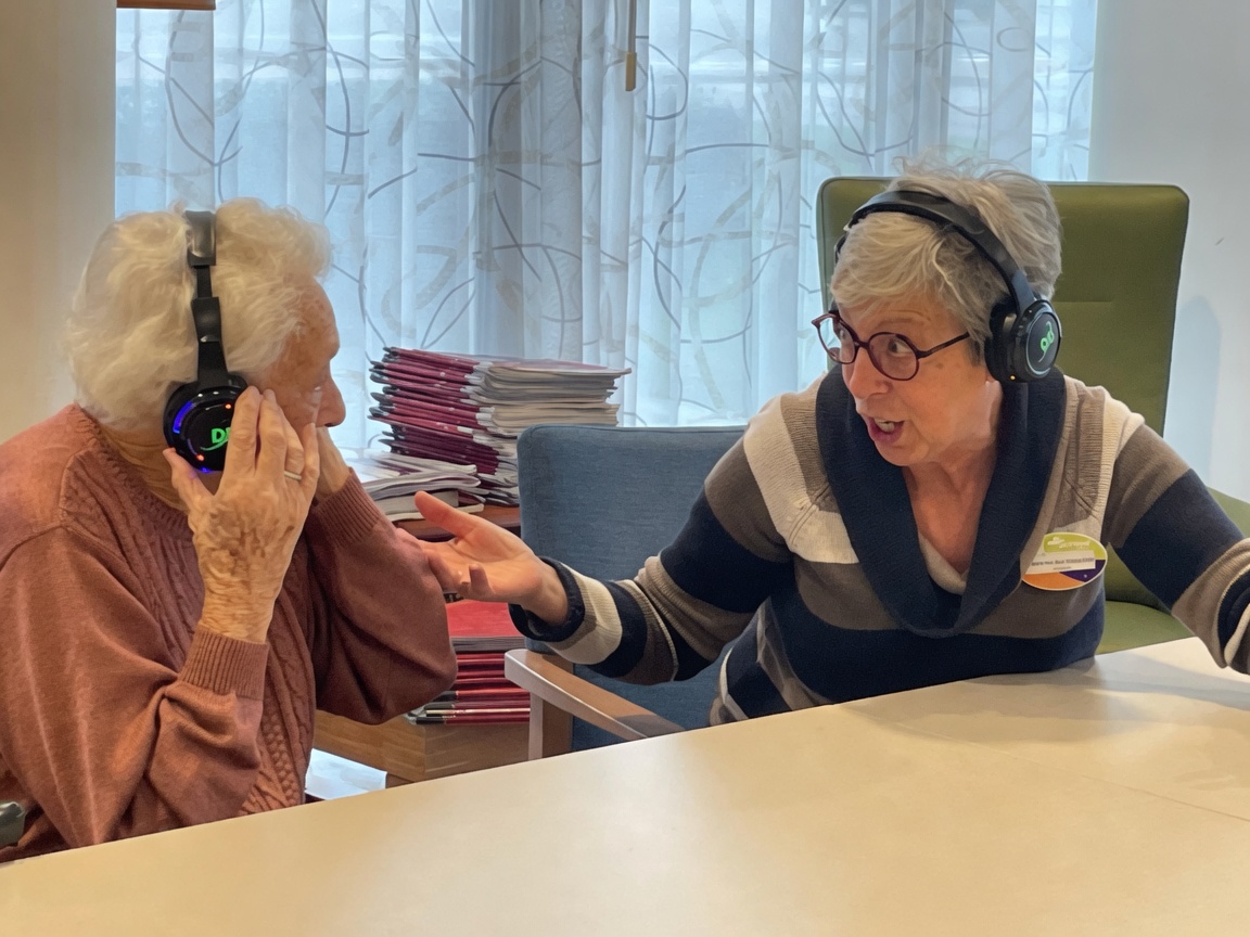 Resident singing along with headphones on