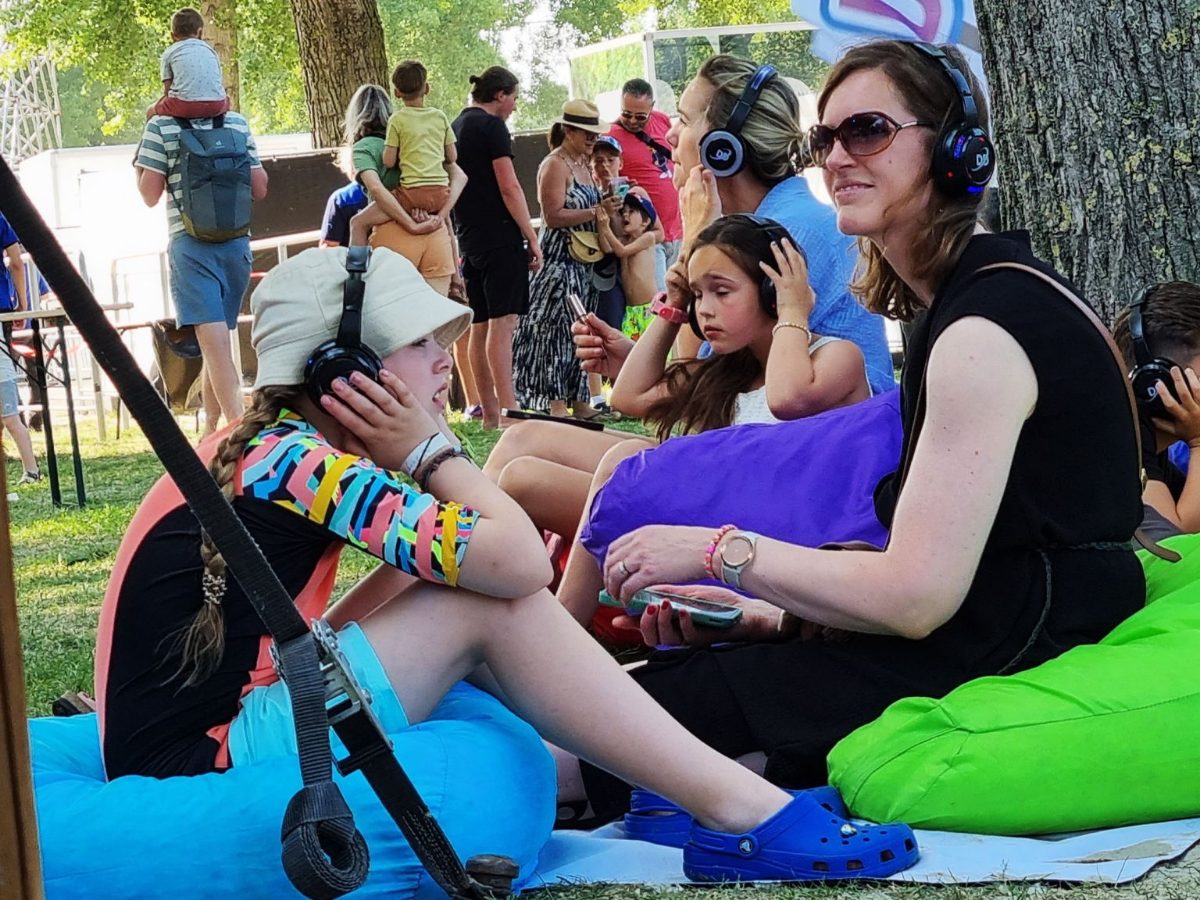Festival crowd with silent disco headphones on the grass